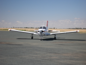 Small aircraft taxing on runway